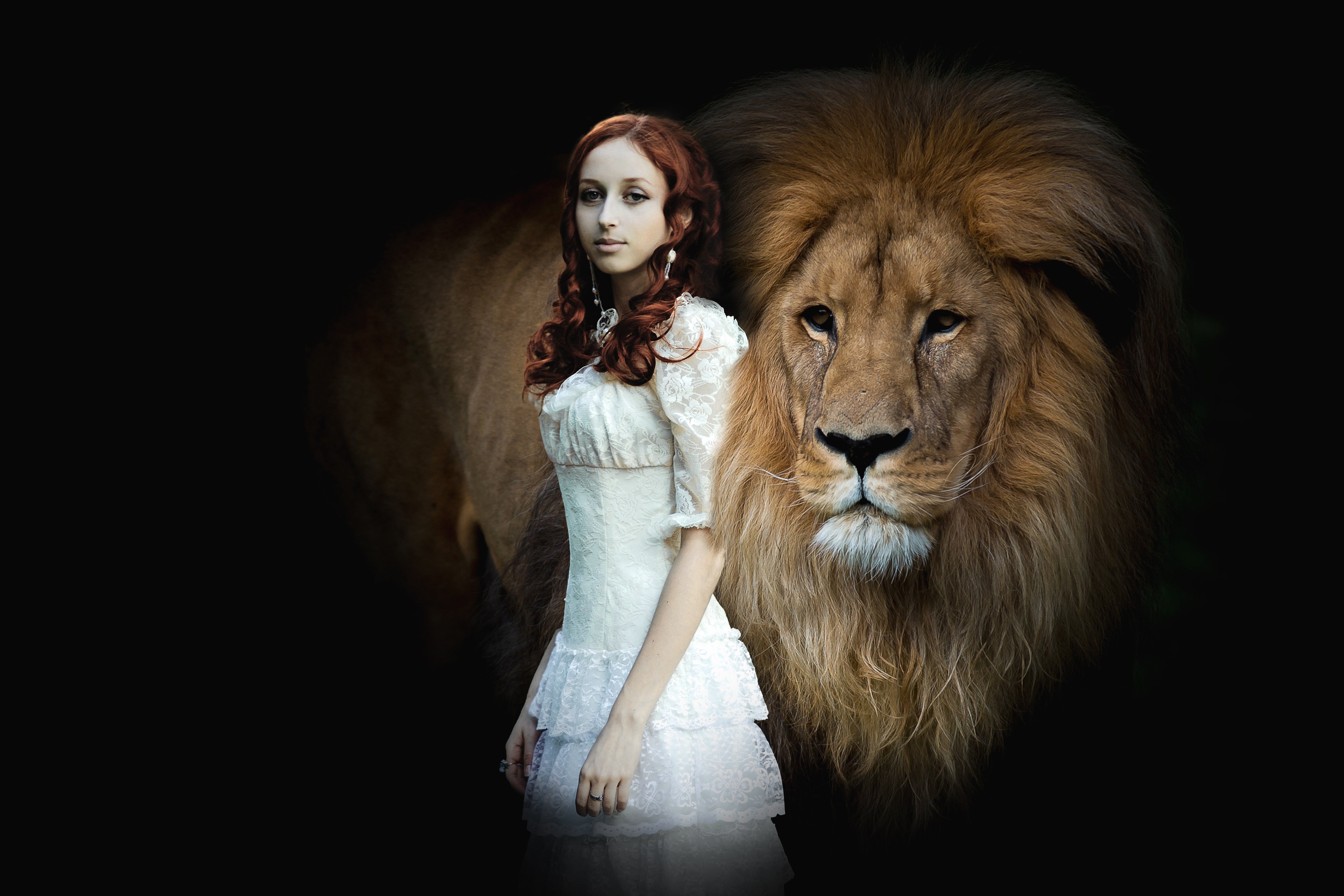 A red haired woman with a Mona Lisa smile in a lacy white dress, guarded by a lion