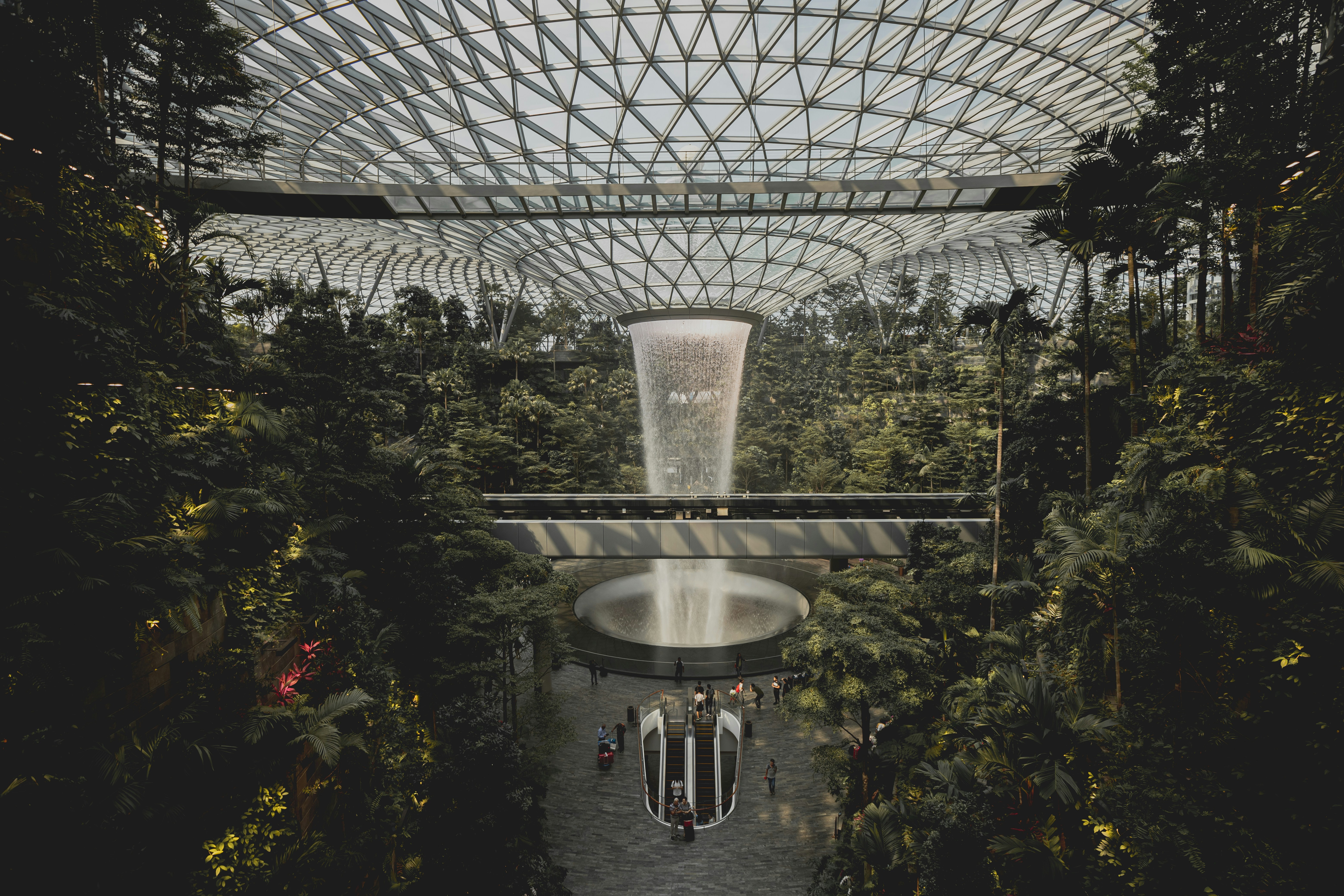 mark-sarmiento-oPhnIKyc4-I-unsplash.jpg A lush biodome garden with a central waterfall