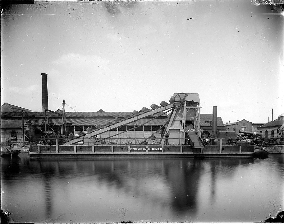 A black-and-white photograph of a bucket dredger